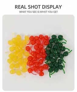 Close-up of colorful miniature resin cherry charms for DIY crafts in red, yellow, and green