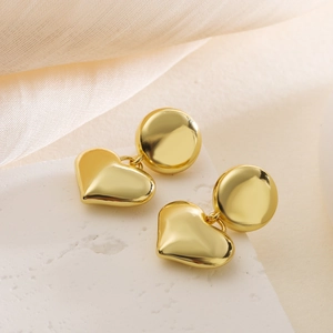 Elegant 18K gold plated heart drop earrings on a minimalist white stone background