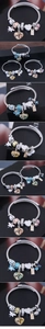 Detailed macro of vintage beaded snake chain bracelets with heart and daisy charms