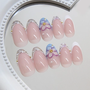 Elegant nude pink French press-on nails with golden beads and purple 3D floral accents