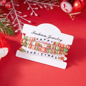 Detail of Christmas beaded bracelet set with Santa charm on a festive red background