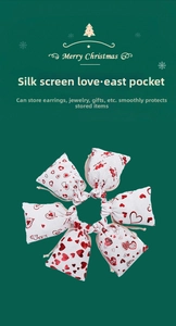 Detail of drawstring pouches with gold heart print for jewelry and wedding favors