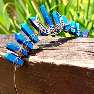 Detail of bohemian crown featuring raw blue crystals and silver moon charms with hand-wrapped wire