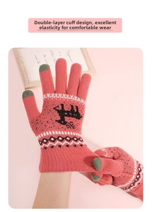 Close-up of pink knit winter gloves with touchscreen tips and reindeer pattern
