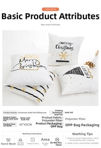 Macro view of white polyester Christmas cushion cover with gold foil Merry Christmas print