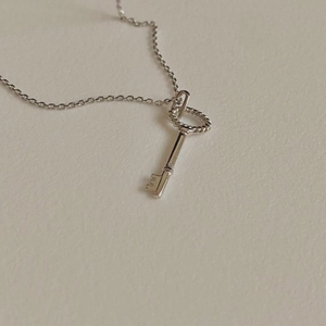 Minimalist 925 sterling silver key pendant necklace with twisted ring detail