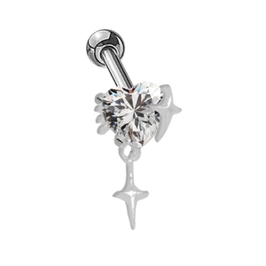 Detailed macro of heart zircon navel piercing with a hanging star pendant
