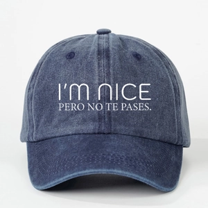 Dark blue washed denim baseball cap with I'M NICE PERO NO TE PASES slogan embroidery