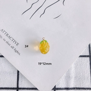 Detail view of yellow pineapple glass pendant charms for DIY jewelry 19x12mm