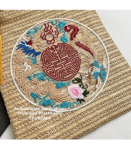 Detailed view of woven straw shoulder bag featuring intricate traditional Chinese embroidery
