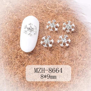 Macro detail of 8x9mm silver alloy snowflake nail charm with sparkling rhinestones