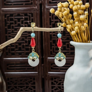 Detail of vintage Chinese tassel earrings with red teardrop beads and white ring charms