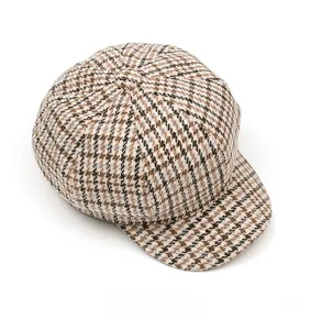 Top view of retro houndstooth newsboy cap with classic brown and black plaid pattern