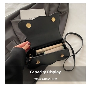 Internal view of black wave edge handbag showing capacity for phone and essentials