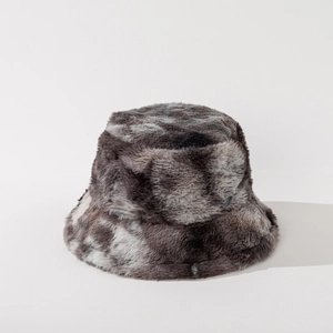 Detailed view of grey and white tie-dye faux fur bucket hat with fluffy winter texture