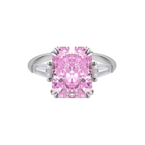 Macro detail of three-stone ring with pink rectangular gem and silver setting