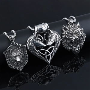 Three punk style stainless steel wolf head pendants with vintage finish on black stand