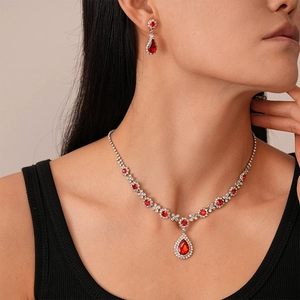 Luxurious retro teardrop jewelry set with red stones and diamonds on a model