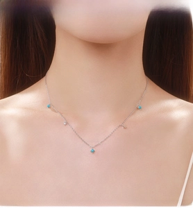 Close-up of S925 silver necklace with turquoise and zircon pendants on a model's neck