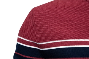 Close-up of the striped knit texture on a burgundy, white, and navy men's sweater