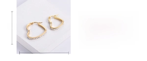 Detail view of heart-shaped gold earrings with sparkling zircons and dimensions