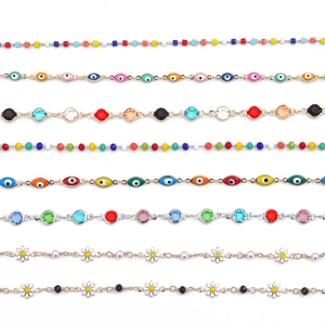 Colorful copper chains with crystal beads, evil eye charms and daisy floral details