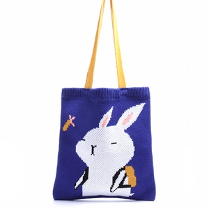 Royal blue knitted tote bag featuring cute white cartoon rabbit and yellow handles
