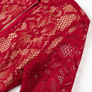 Detail of burgundy lace dress showing intricate hollow texture and hidden zipper
