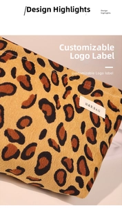 Close-up of leopard print corduroy fabric texture and woven logo on the cosmetic bag