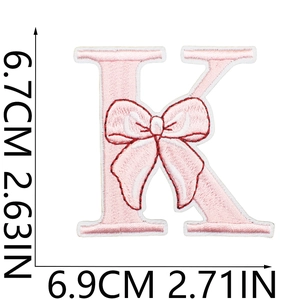 Detail showing letter K embroidery patch with pink bow and precise dimension measurements
