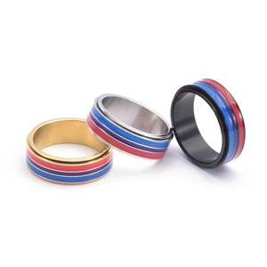 Close-up of three rotating stainless steel rings with colorful enamel striped inlay