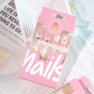 French tip press on nails with 3D floral accents and pink gradient in a windowed box