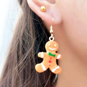 Handmade asymmetrical gingerbread man drop earrings with festive cartoon cookie design