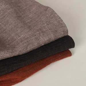 Detail of linen texture and fabric weave in khaki, brown, and red on summer bucket hats