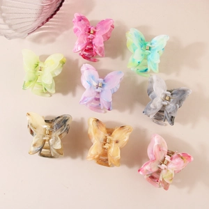Set of 8 colorful butterfly hair claws in acetate marble finish on beige background