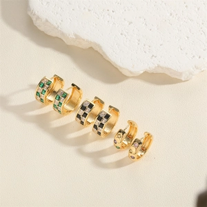 Three pairs of elegant gold hoop earrings featuring green, black, and colored cubic zirconia