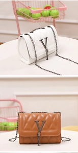 Detail view of quilted leather crossbody bags with V-shaped metal clasp and tassel accents