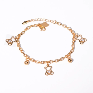 Detail of gold chain bracelet with hollow bear charms, white zircons, and 18K hallmark