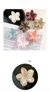 Detail of colorful marble-textured flower claw clips in soft pastel cream colors