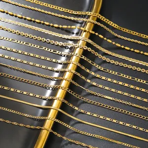 Detail view of various gold-plated stainless steel chain styles including Figaro and snake links