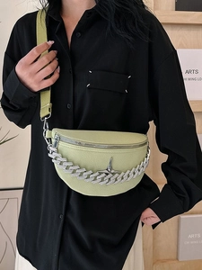 Light green half-moon crossbody bag with chunky silver chain and star buckle on model