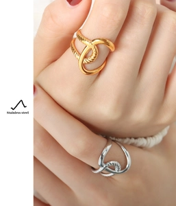 Detail showing intertwined 18K gold plated stainless steel rings with braided texture
