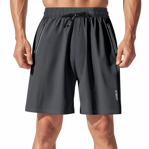Detail of men's quick-dry sports shorts showing elastic waistband and reflective logo