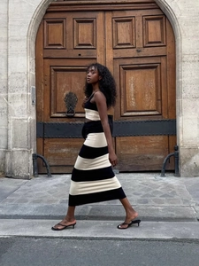 Women's chic black and white striped knit set with a cropped top and slim maxi skirt