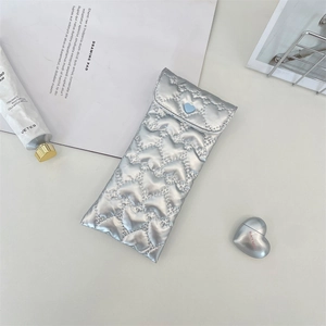 Quilted silver PU leather pouch with heart patterns and blue button closure for glasses