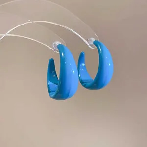 Minimalist bright blue acrylic C-shape hoop earrings with smooth glossy finish