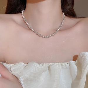 Close-up of manta rose pearl necklace with sparkling rhinestones on model's neck