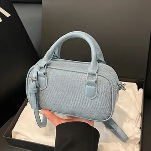 Light blue Boston bag in twill fabric with leather trim and detachable shoulder strap
