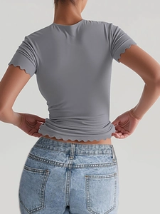 Slim fit grey yoga t-shirt for women featuring wavy edge details and elastic fabric back view