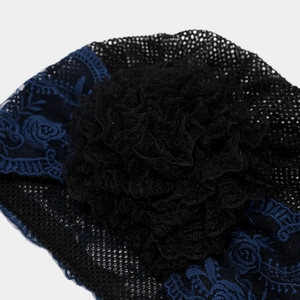 Detail of elegant black mesh lace hat featuring 3D tulle flower and blue floral embroidery